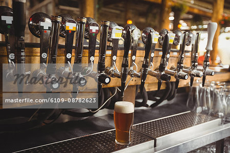Close-up of beer pump in a row at bar