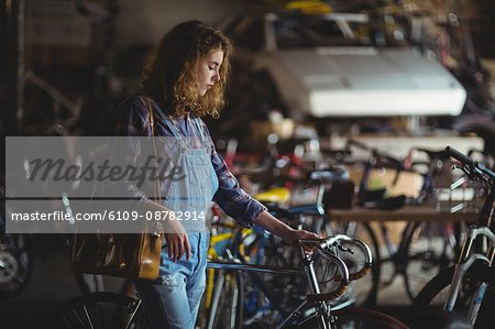 Mechanic examining a bicycle handle bar in workshop