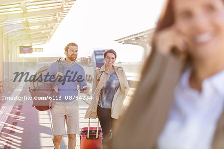 Couple with luggage at train station