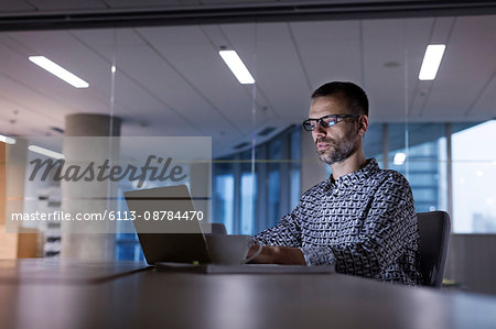 Businessman working late at laptop in office