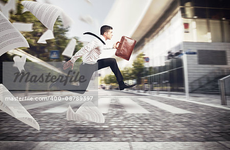 Businessman runs on street to go to work with his bag