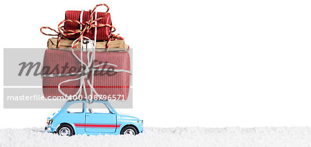 Blue retro toy car delivering Christmas or New Year gifts, isolated on white