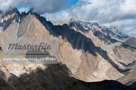 Light and shadow move across the jagged peaks of the Zanskar range seen from the top of the Dung Dung La in Ladakh, Himalayas, India, Asia