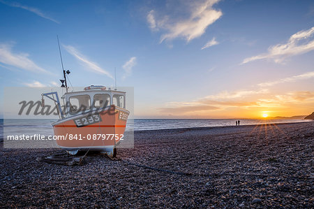Fishing boat moored on Branscombe Beach at sunset, Seaton, East Devon, England, United Kingdom, Europe