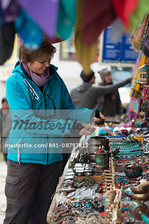 Shopping for souvenirs in Namche Bazaar, the main town during the Everest base camp trek, Khumbu Region, Nepal, Asia