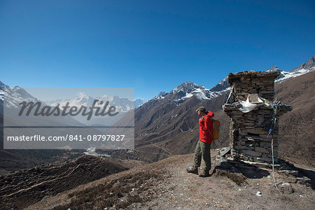 A trekker in the Everest region looks down on the Khumbu Valley towards Pangboche, Khumbu Region, Himalayas, Nepal, Asia