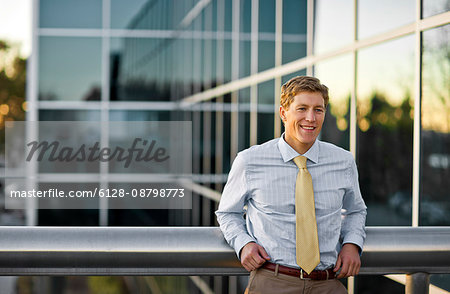 Young businessman standing on an office building.