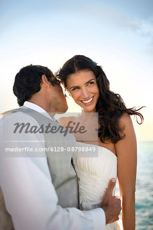 Portrait of a young newlywed couple tenderly embracing after their wedding.