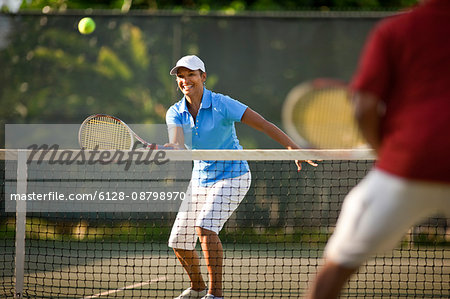 Couple playing tennis