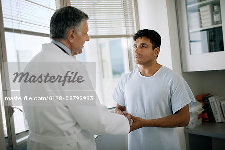 Senior doctor consulting with a patient after a medical exam.