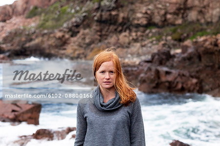 Portrait of young redhead woman on seaside
