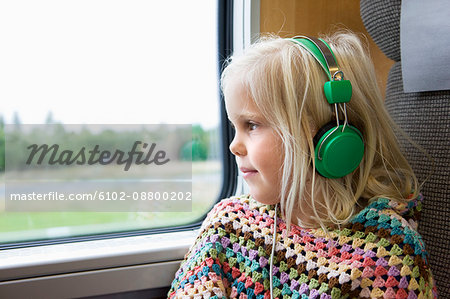 Girl listening to music while traveling on high speed train