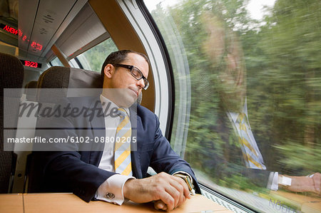 Businessman having nap on high speed train