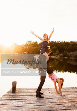 Sisters playing on jetty