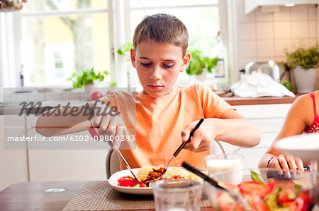 A boy eating dinner