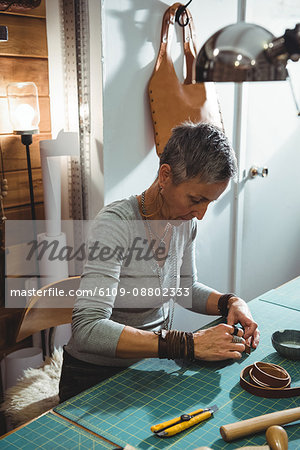 Attentive craftswoman working in workshop