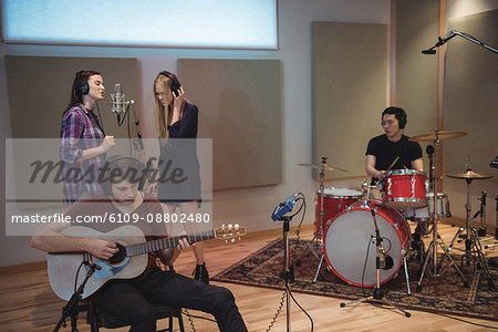 Music band performing in recording studio