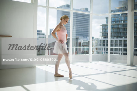 Ballerina practicing a ballet dance in ballet studio