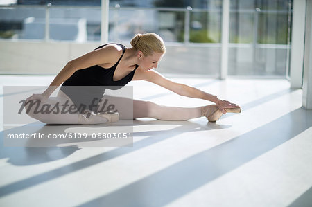 Ballerina performing a split in the studio