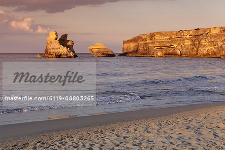 Rocky coast near Torre dell'Orso, Due Sorello Rocks (Two sisters) at sunset, Adriatic Sea, Lecce province, Salentine Peninsula, Puglia, Italy, Mediterranean, Europe