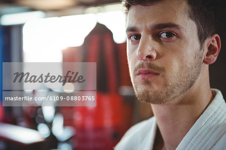 Portrait of confident karate player in fitness studio