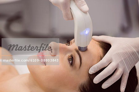 Female patient receiving cosmetic treatment at clinic