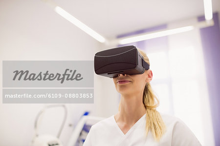 Female doctor wearing virtual reality headset in clinic