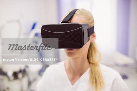 Female doctor wearing virtual reality headset in clinic