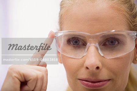 Close up of female doctor wearing protective glasses in clinic