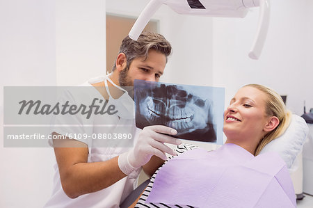 Dentist showing x-ray to the patient in clinic