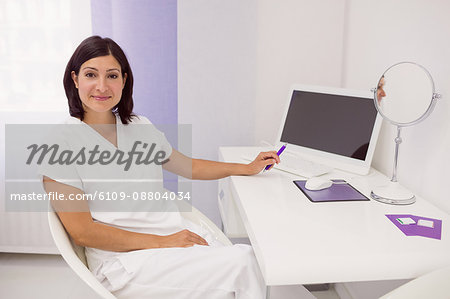 Portrait of dermatologist at her desk in clinic
