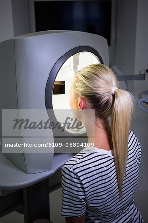 Woman receiving aesthetic laser scan in clinic