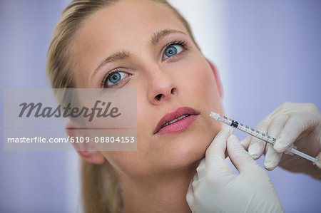 Close-up of female patient receiving a botox injection on face