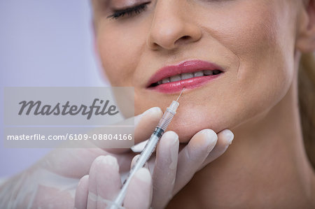 Close-up of a woman receiving botox injection at clinic