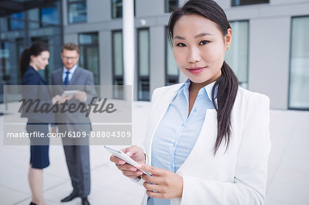 Portrait of a businesswoman using mobile phone in office