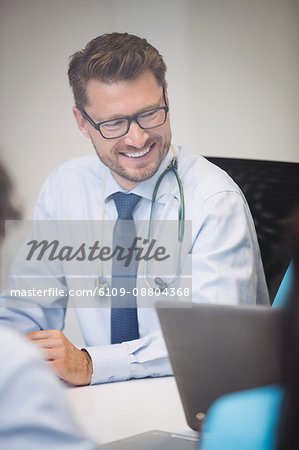 Smiling doctor in meeting at conference room