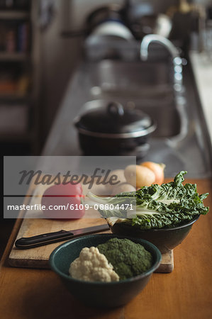 Potatoes, onion, lettuce with broccoli on cutting board in kitchen worktop