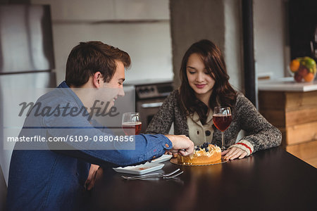 Couple celebrating together in living room at home