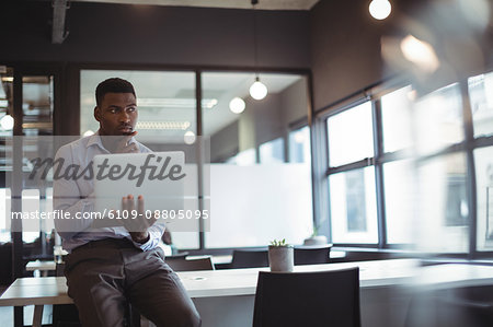 Thoughtful businessman working over laptop in office