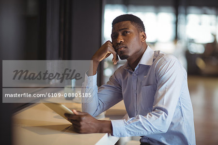 Businessman using digital tablet in office