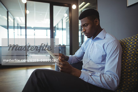 Portrait of businessman using digital tablet in office