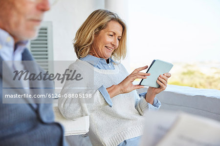 Senior woman using digital tablet on patio