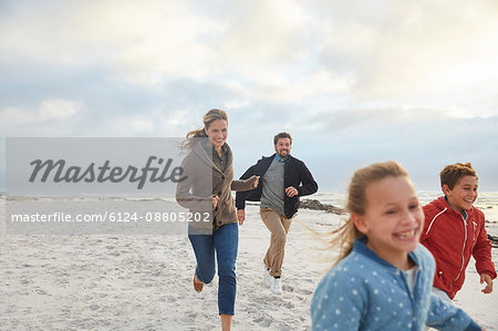 Playful family running on beach