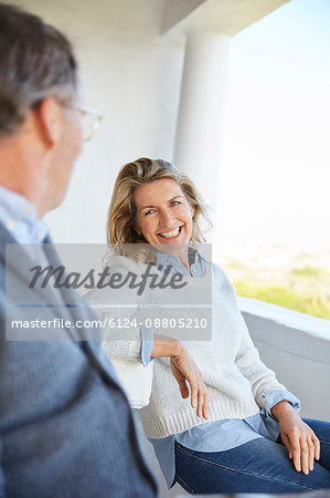 Smiling senior couple talking on patio
