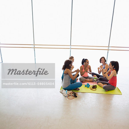 Women gesturing with fists in exercise class gym studio