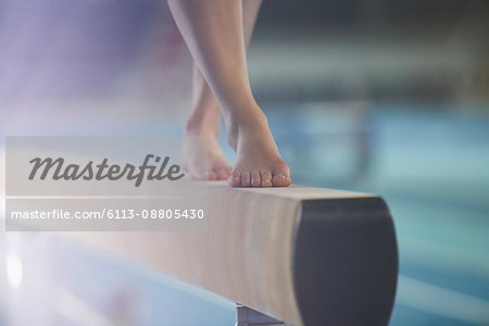 Bare feet of female gymnast performing on balance beam
