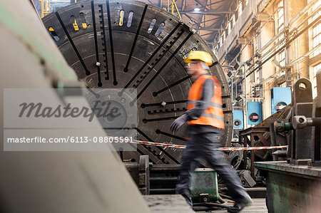 Steel worker walking in factory