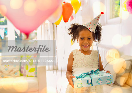 Portrait smiling girl holding birthday gift