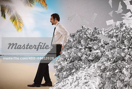 Businessman pushing with fatigue a big pile of paperwork