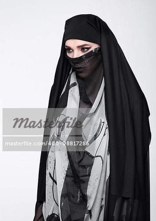 Beautiful eyes woman wearing fashion burka on grey background